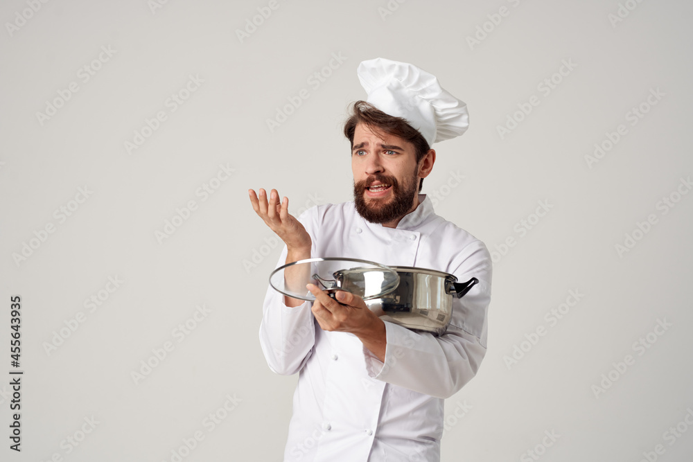professional chef tastes food with a pan in his hands restaurant light background professional chef tastes food with a pan in his hands restaurant light background