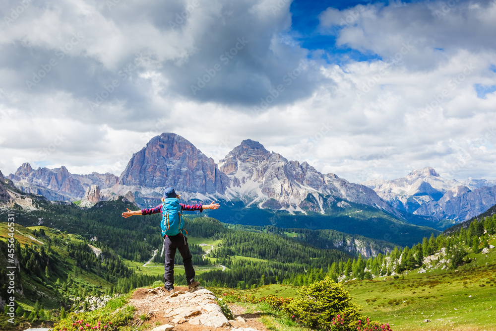 Hiker Young Woman With Backpack Rises To The Mountain Top. Discovery Travel Destination Concept