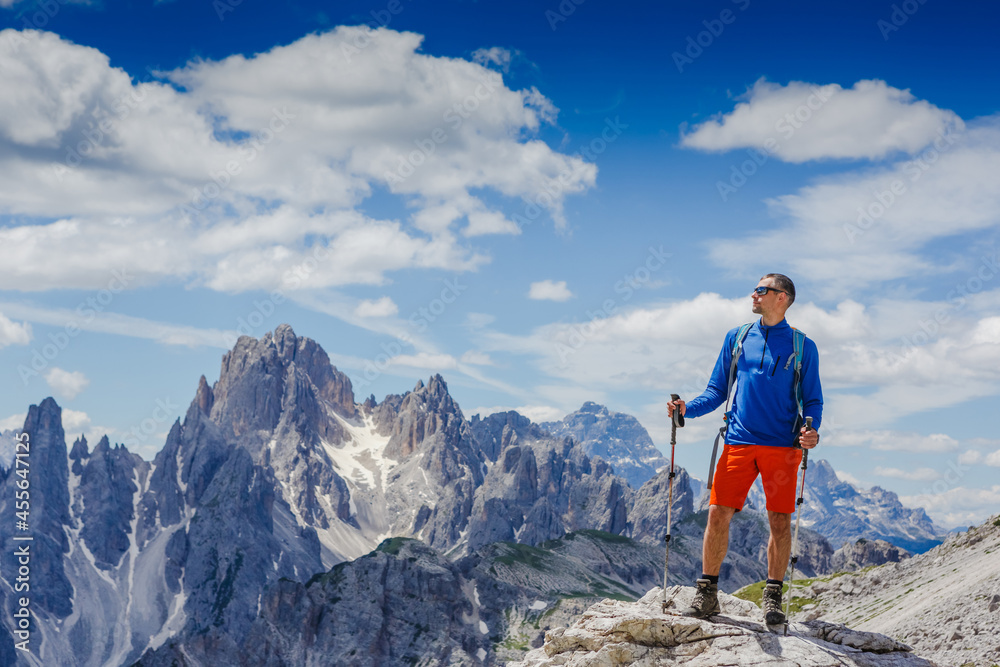 Man with backpack hiking in Dolomites mountains. Travel, lifestyle, adventure, mountaineering, sport concept. Tre cime di lavaredo national park, south tyrol
