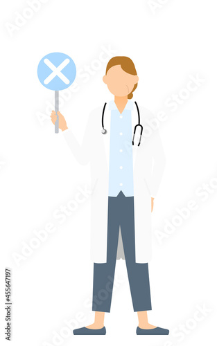 白衣のシニア女性医師がバツの棒を持つ・答え合わせのポーズ © TKM