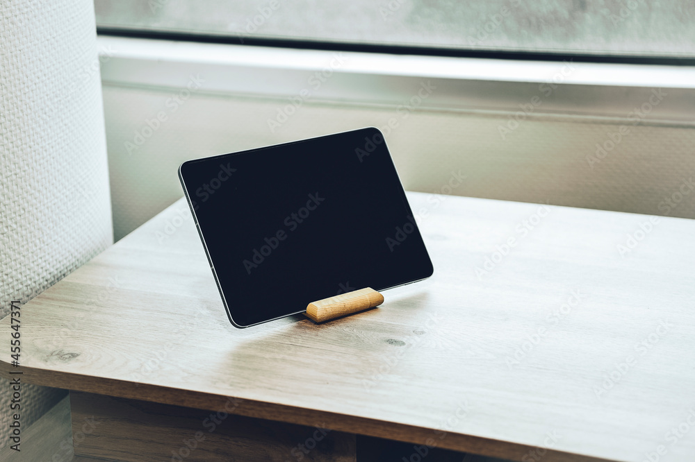 Digital tablet on a wooden table Digital tablet on a wooden table