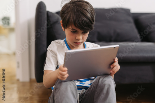 boy using digital tablet at home