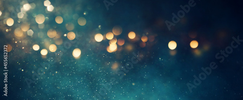 background of abstract glitter lights. gold, blue and black. de focused. banner