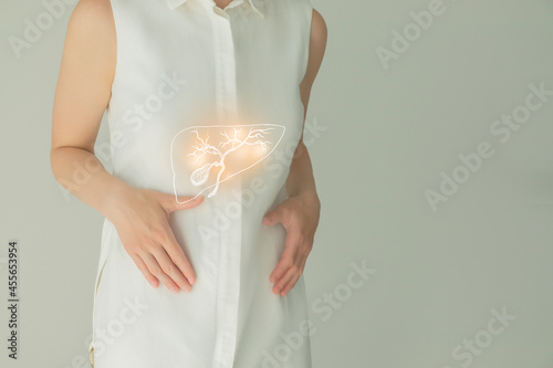 Woman in white clothes holding virtual gall bladder in hand. Handrawn human organ, detox and healthcare, healthcare hospital service concept stock photo