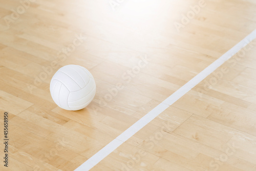 Volleyball ball and white line on wooden court. Horizontal education and sport poster, greeting cards, headers, website