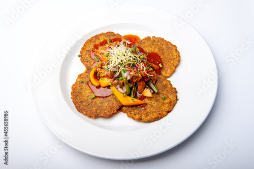 Potato pancakes with meat mixture and vegetables