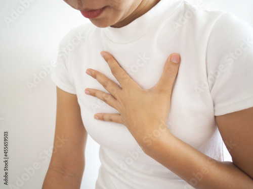 Diaphragmatic hernia. Asian woman have a burning sensation in their breasts. chest pain, shortness of breath. health concept. closeup photo, blurred. photo