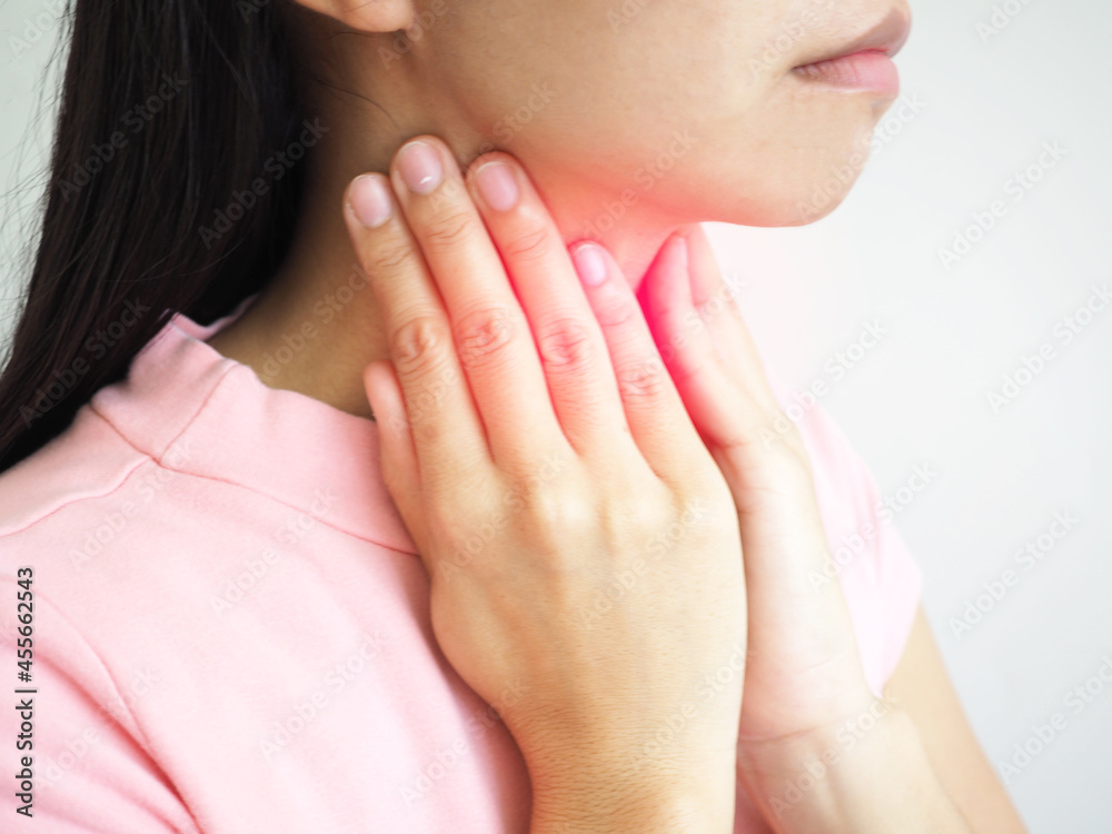 Woman suffering from sore throat on white background. closeup photo, blurred. Woman suffering from sore throat on white background. closeup photo, blurred.