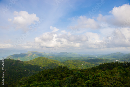 Spectacular view of a lush green mountains and beautiful clouds during monsoon. A scenic site from Munar, Kerala, India.