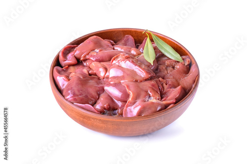 raw chicken or goose liver with bay leaf in a clay bowl close-up, isolated on a white background
