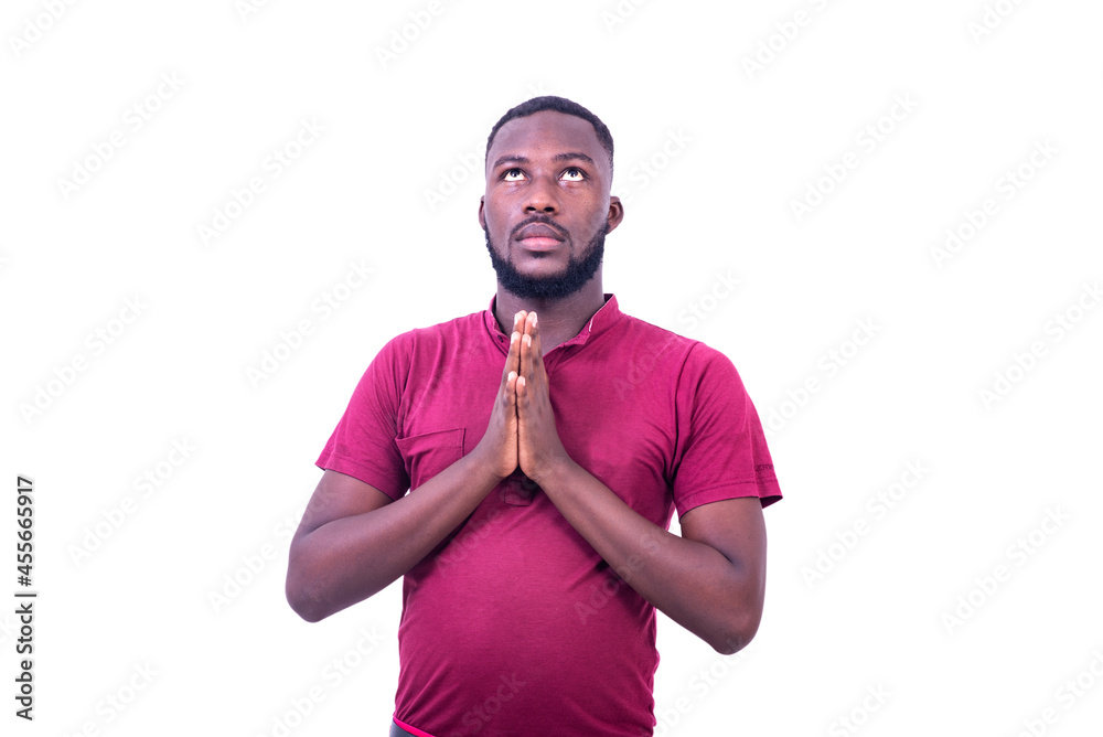 portrait of a young man praying. - obrazy, fototapety, plakaty 
