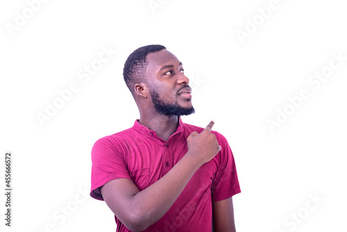 handsome young man pointing finger back and looking aside.