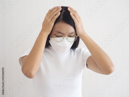 An upset woman put her hand on her head. headache caused by stress tension anxiety and migraines. closeup photo, blurred. photo