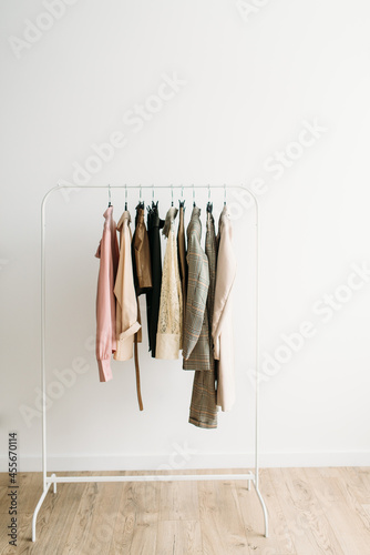 Rack with capsule clothes in beige colors