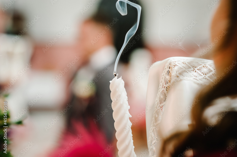 Candle with white smoke on blurred background. Select focus. White smoke when the candle goes out.