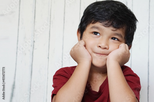 Cute Asian child little Thai boy 4 year old smile make a happy face concept.