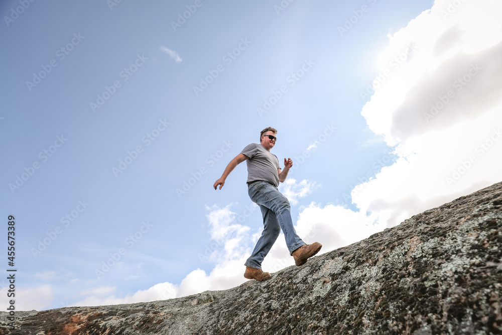 Man running and jumping on rocks in nature Man running and jumping on rocks in nature