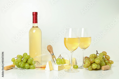 Concept of white wine tasting on white background