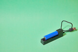 charger for blue 18650 battery on green background