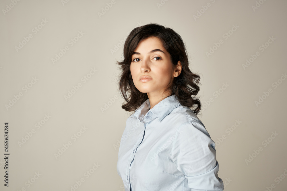 brunette in blue shirt cropped view light background elegant style brunette in blue shirt cropped view light background elegant style