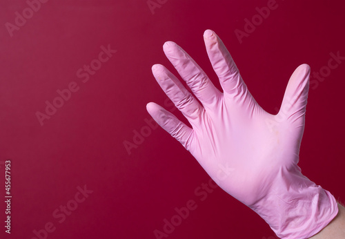 male hand in a medical glove on a black background