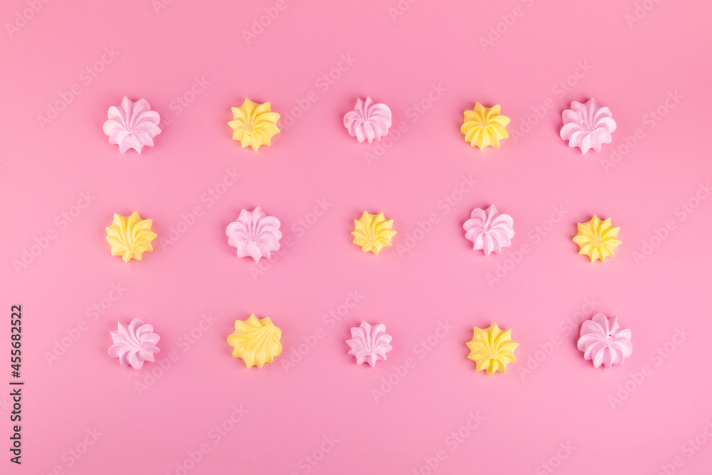Pink and yellow meringues on a pink background. Sweet beze. Food. Dessert. Cookie - obrazy, fototapety, plakaty 