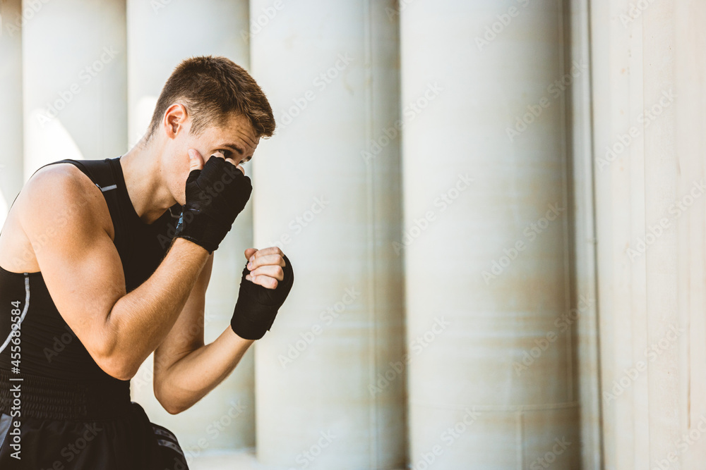 Man exercising and fighting in outside, boxer in gloves. male boxer portrait Man exercising and fighting in outside, boxer in gloves. male boxer portrait