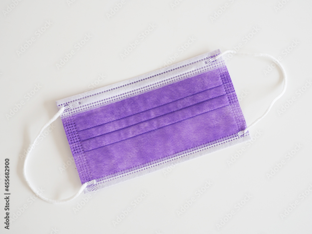Purple mask used to protect against corona virus and PM2.5 dust on white background. Purple mask used to protect against corona virus and PM2.5 dust on white background.