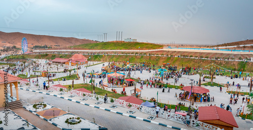 cityscape for an amusement park and children games with nice ferris wheel at night with bleu sky on hodna bey magra m'sila in algeria