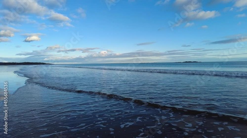 Blue Sky at Day's End on Tidal Flat with Gentle Waves Flooding In.