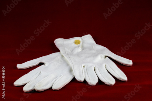 White Gloves Isolated on a Red Table Cloth