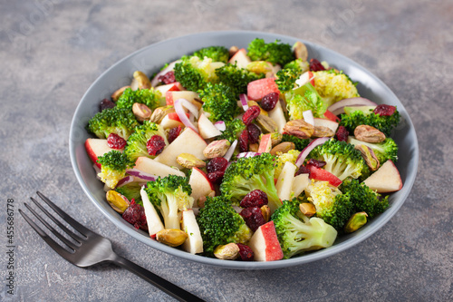 Vászonkép healthy broccoli salad with apple onion dried cranberries pistachio