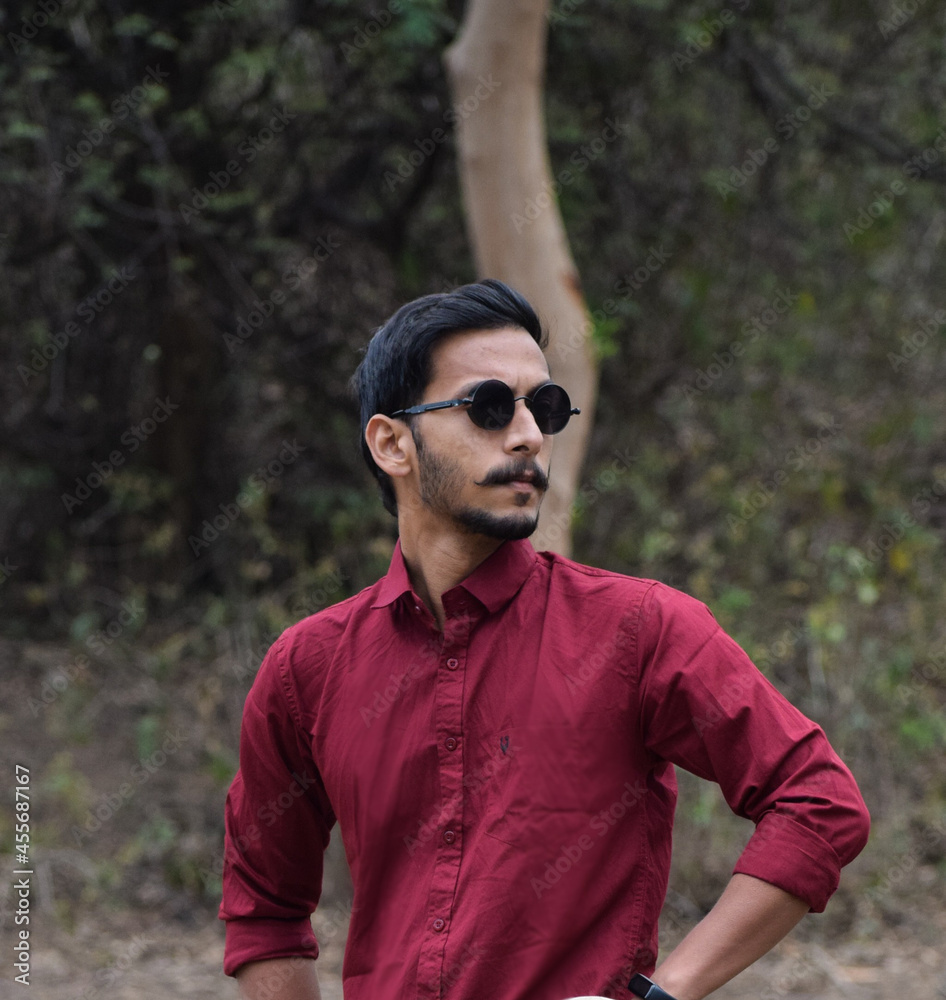 portrait of a indian handsome man wearing sunglasses. young man with mustaches. portrait of a indian handsome man wearing sunglasses. young man with mustaches.