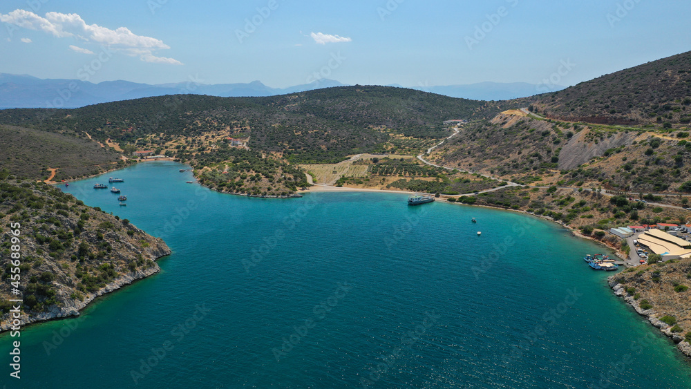 Aerial drone photo of large fish farming - breeding unit of sea bass and sea bream in huge round cages with latest technology automatic feeding system, calm deep sea of Anemokambi, Galaxidi, Greece