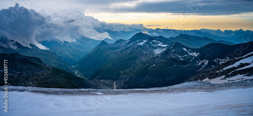 Fototapeta Naklejka Na Ścianę i Meble -  Rocky alpine mountains morning panorama. Cloudy sunrise on summer day. Grossglockner Mountain, Hohe Tauern National Park, Austrian Alps