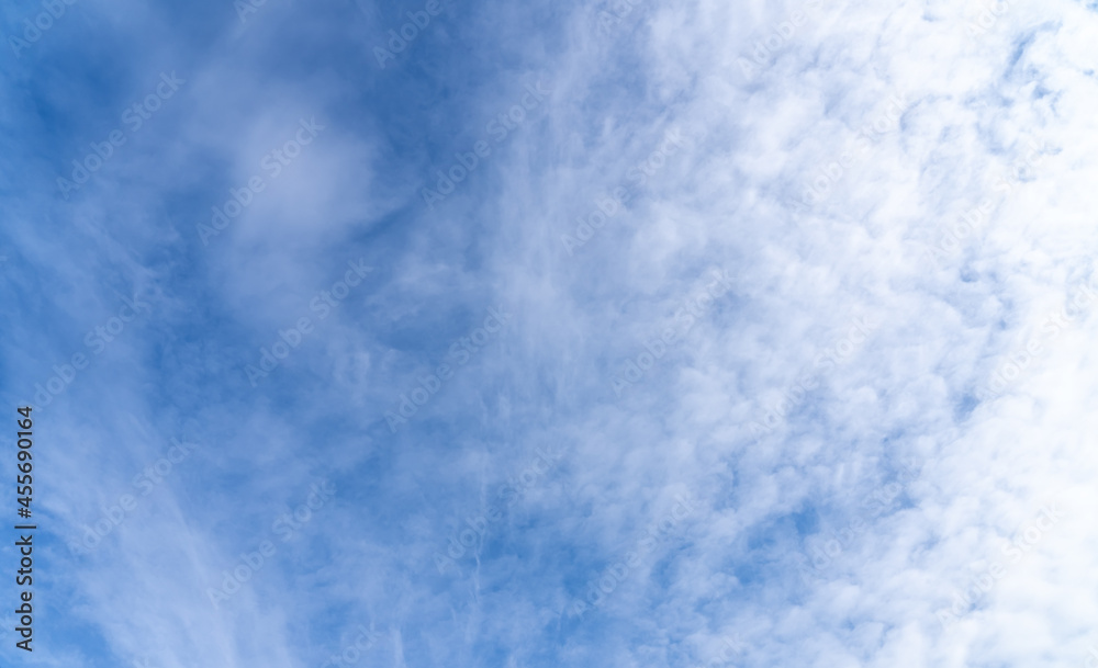 Natural daylight and white and dark blue clouds floating on blue sky. White fluffy clouds and blue sky