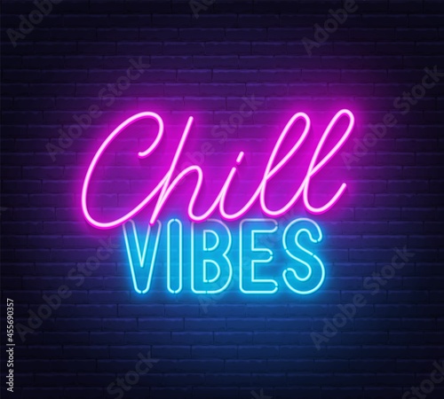 Chill Vibes neon lettering on brick wall background.