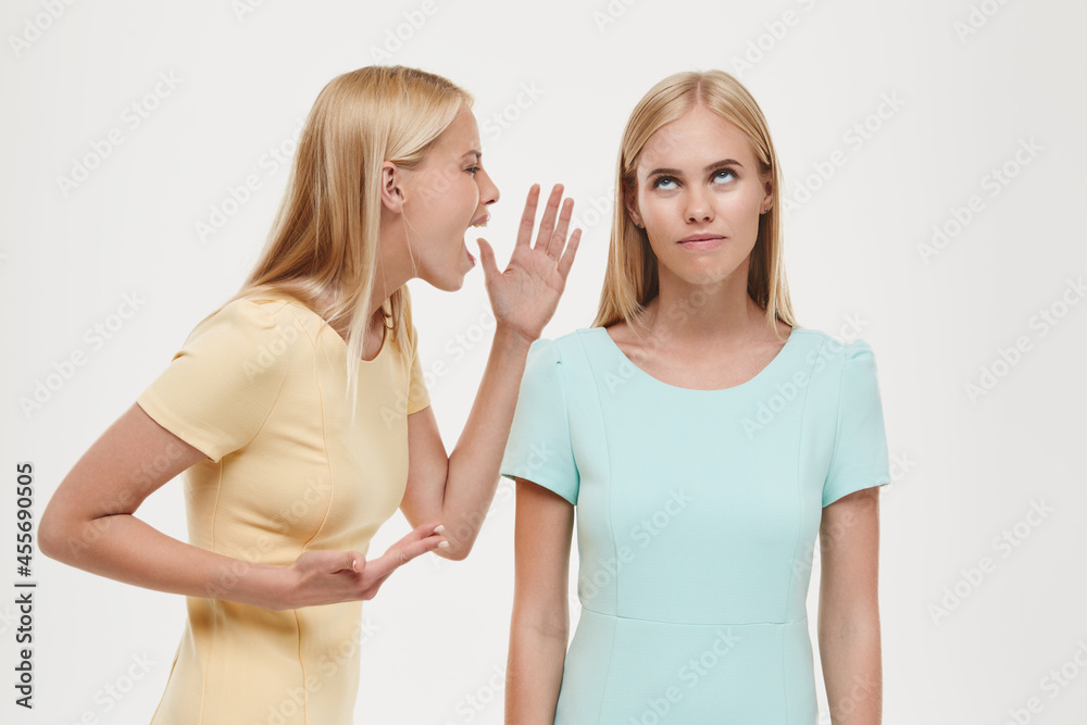 Girl screaming on girlfriend with skeptical face Girl screaming on girlfriend with skeptical face