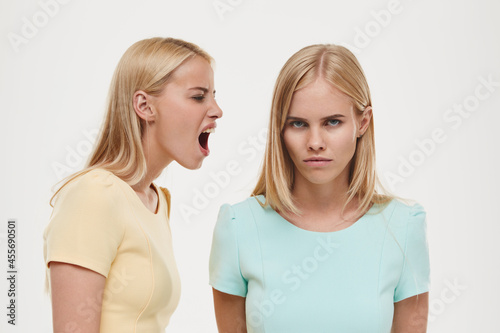 Irritated girl scream on dissatisfied girl friend