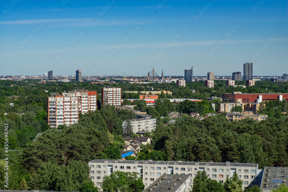Summer cityscape of Riga. Top view. Urban architecture. Green trees.