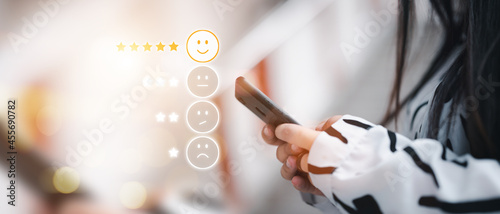 Businessman presses a smartphone Laughing icons on the virtual screen, such as assessments, polls, recommendations, and preferences.
