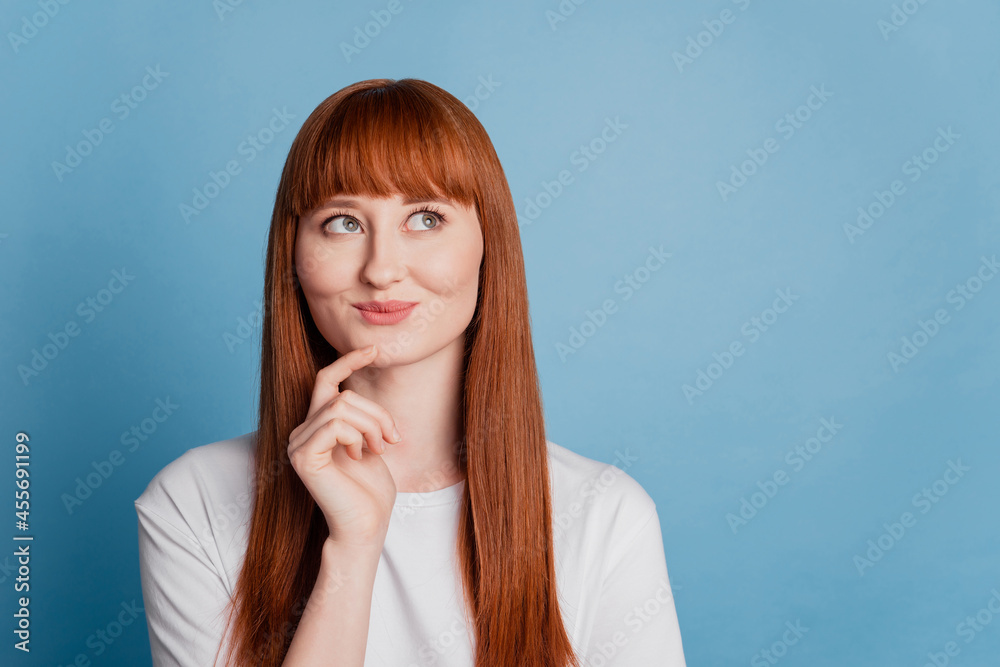 Photo of lady look empty space think isolated on blue background Photo of lady look empty space think isolated on blue background