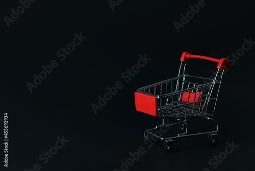  shopping cart or trolley on black background with copy space.