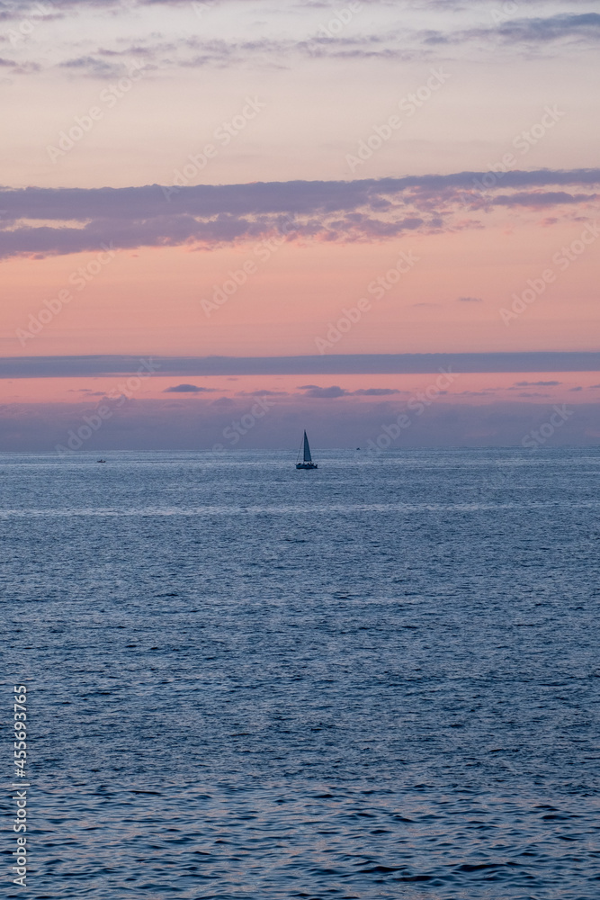 sailboat in the sea at sunset