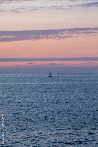 sailboat in the sea at sunset © Joost van Os