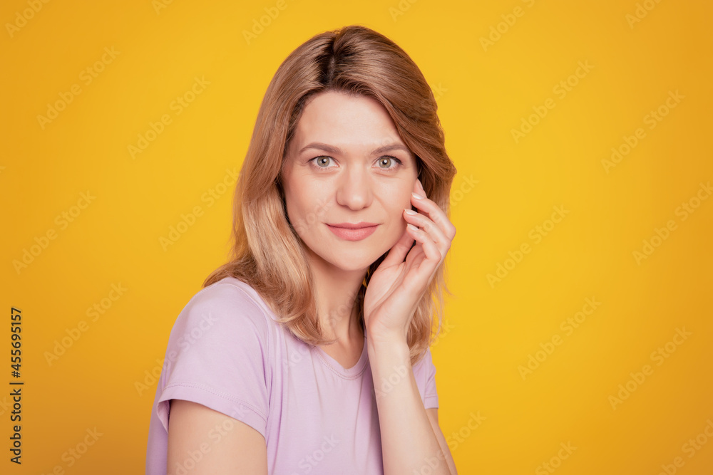 Portrait of charming tender dream lady natural sensual pose hand cheekbone on yellow background Portrait of charming tender dream lady natural sensual pose hand cheekbone on yellow background