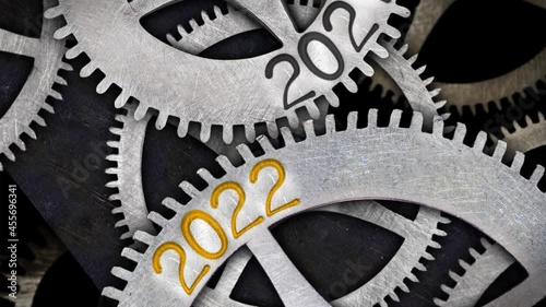 Tooth wheels in forward and backward rotation with number 2022 incoming and 2021 passing. New Year concept. High quality 4k video.