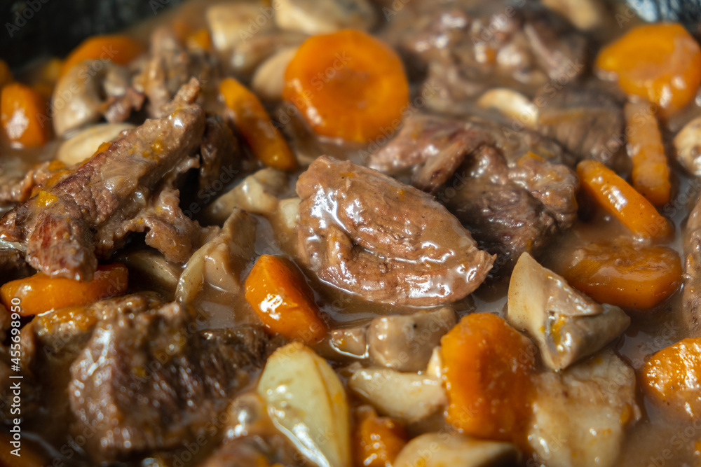 Close up Ready of Beef Burgeoning beef dish in a frying pan. meat, carrots and onions and mushrooms. Appetizing sauce. Slow food concept. Close-up Close up Ready of Beef Burgeoning beef dish in a frying pan. meat, carrots and onions and mushrooms. Appetizing sauce. Slow food concept. Close-up