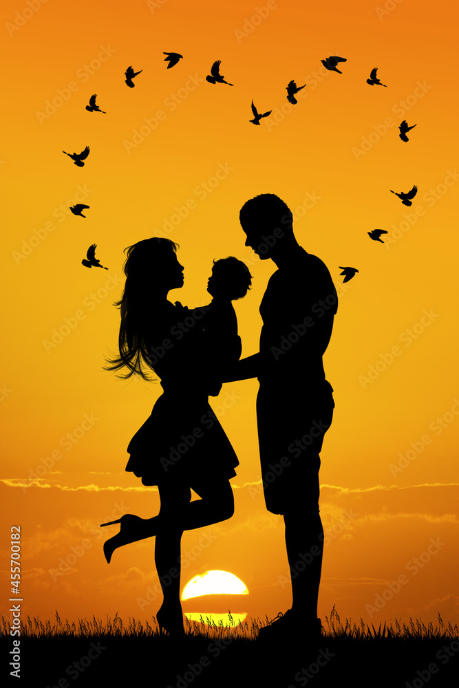 silhouette of young family at sunset silhouette of young family at sunset
