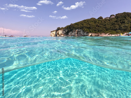Underwater sea level split photo of beautiful paradise turquoise exotic beach of Voutoumi probably the best in Greece, Ionian island of Antipaxos